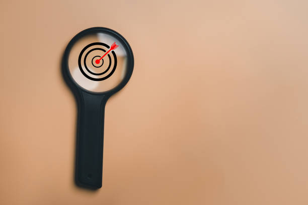 istock Board with magnifier glass for focus business objective, isolated background and copy space. Search, goal, target, strategy concept. 1436076829