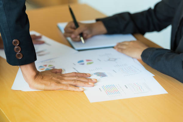 istock Manager consulting with employee in power manner about business target problem , business reports solutions with graph, diagram ,sale volume, business reports, Goal, target setting concept 1436077642