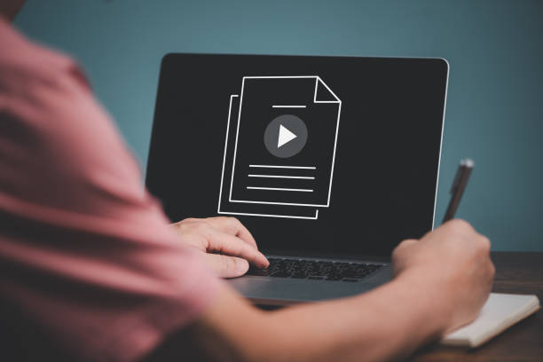 istock E learning concept. Casual business man studying online course via website or page on computer and writing on notebook. 1436077818