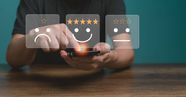 istock Customer service and Satisfaction concept ,Business people are touching the virtual screen on the happy Smiling face icon to give satisfaction in service. rating very impressed. 1436078192