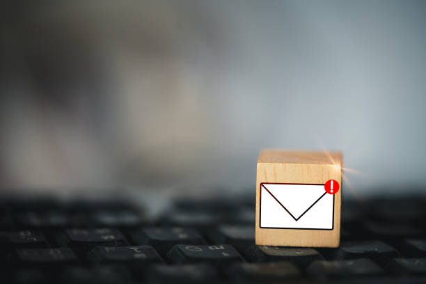 istock New email graphic symbol on wooden block over black computer keyboard 1436079494