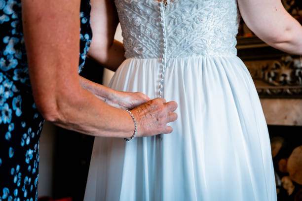 istock Wedding dress being buttoned up 1436079705