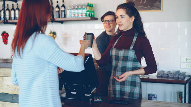 istock Young customer purchasing takeout coffee in modern coffee shop. 1436081597