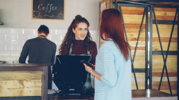 istock Young customer purchasing takeout coffee in modern coffee shop. 1436081835