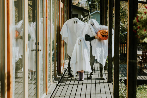 istock Mother, Father and daughter playing ghosts during Halloween 1436081985