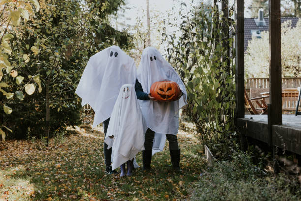 istock Mother, Father and daughter playing ghosts during Halloween 1436082034
