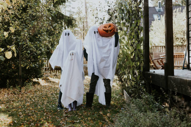 istock Mother, Father and daughter playing ghosts during Halloween 1436082077