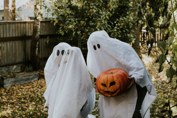 istock Mother, Father and daughter playing ghosts during Halloween 1436082082
