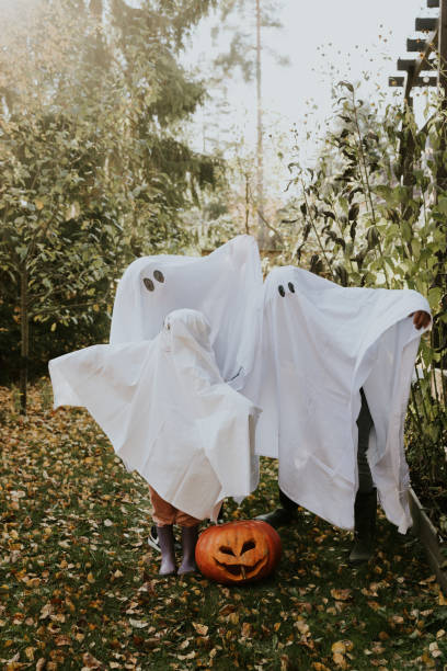 istock Mother, Father and daughter playing ghosts during Halloween 1436082083