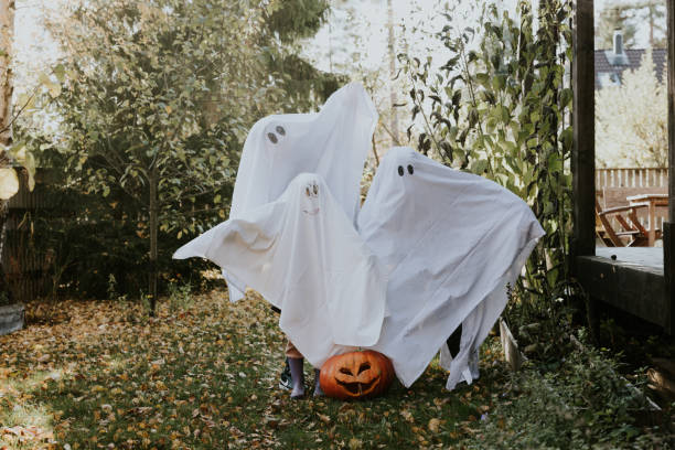 istock Mother, Father and daughter playing ghosts during Halloween 1436082612