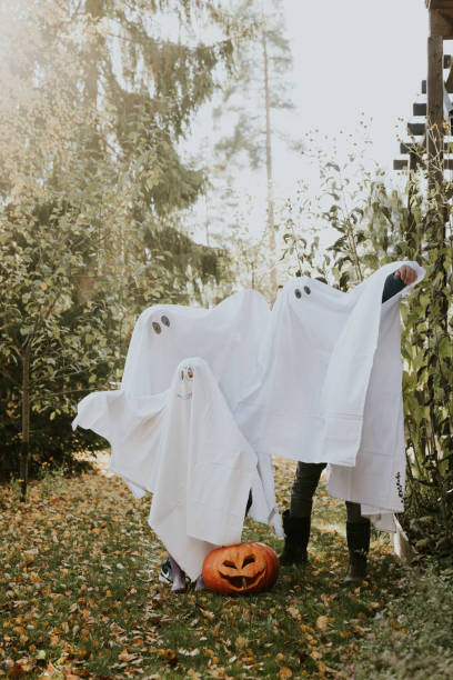 istock Mother, Father and daughter playing ghosts during Halloween 1436082613