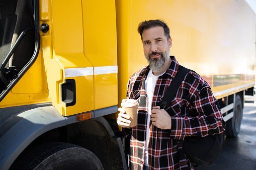 Portrait of a mature truck driver on a coffee break