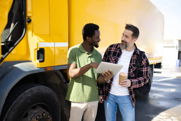 istock Two colleagues truck drivers looking their driving route on a tablet 1436082682