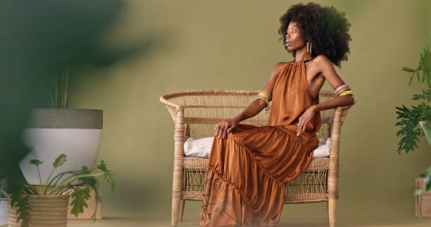 african, fashion and black woman in tropical studio design to model interior design, furniture and plants on green background. afro woman sitting on chair mockup for beauty, natural skin and wellness - human hair retro revival old fashioned beauty imagens e fotografias de stock