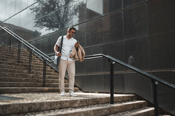 istock Business man walking down the stairs 1436083724