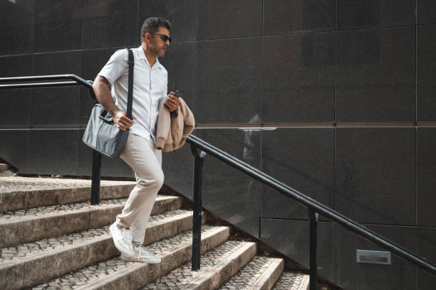 istock Business man walking down the stairs 1436083995