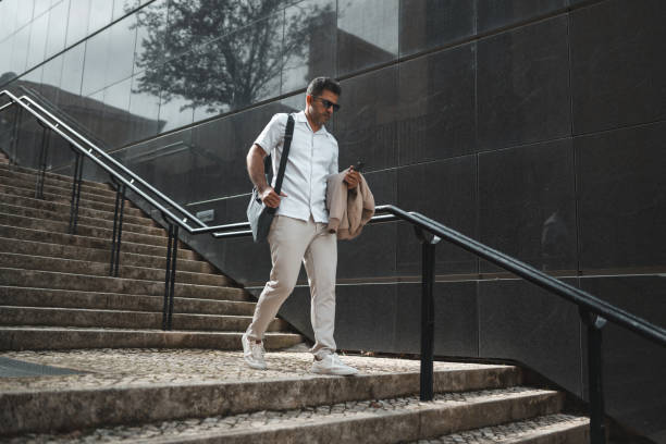 istock Business man walking down the stairs 1436084588