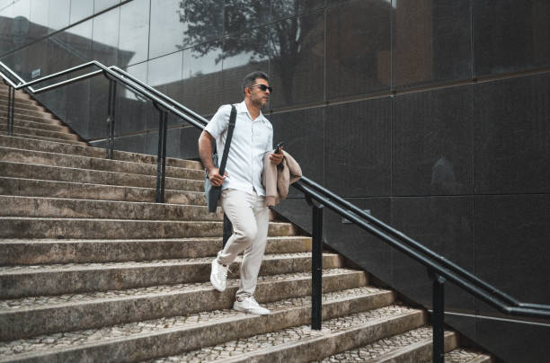 istock Business man walking down the stairs 1436084673