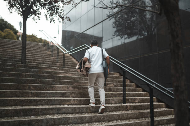istock Business man walking up the stairs 1436084687
