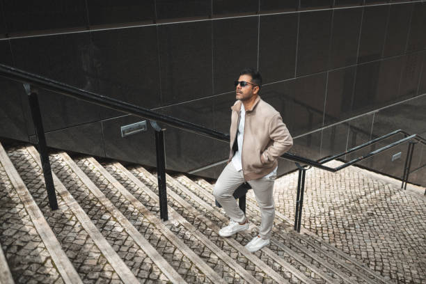 istock Business man walking up the stairs 1436084836
