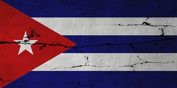 Cuban Flag on cracked wall background.