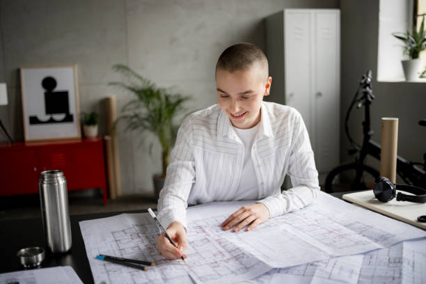 istock Bald smiling young woman working at her office 1436087500