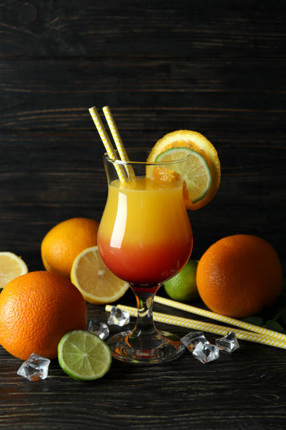 istock Tequila sunrise cocktail and ingredients on wooden table 1436089635