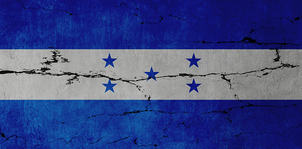 Honduran Flag on cracked wall background.