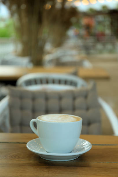 istock Cup of coffee on wooden table in restaurant 1436091790