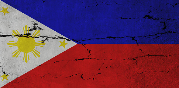 Philippines Flag on cracked wall background.