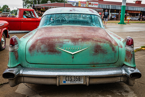 Des Moines, IA - July 01, 2022: High perspective rear view of a 1956 Cadillac 62 Sedan DeVille at a local car show.