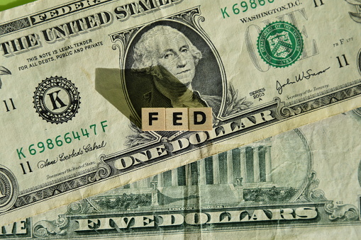 the word fed with wodden cubes on dollar banknotes