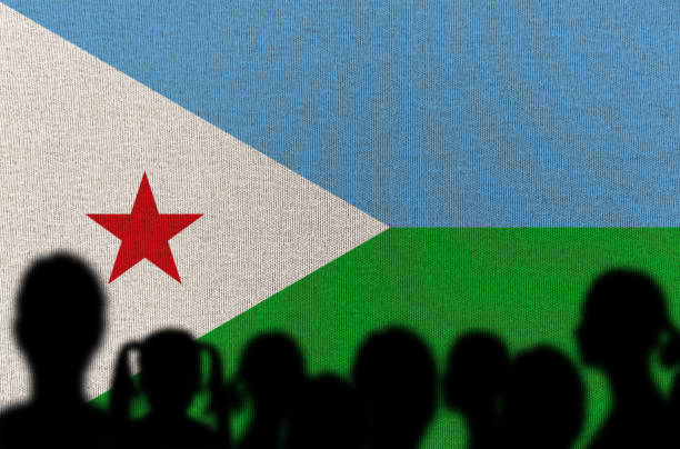 Chef holding blank whiteboard menu on Djibouti flag background. Cook wearing uniform pointing space for text.