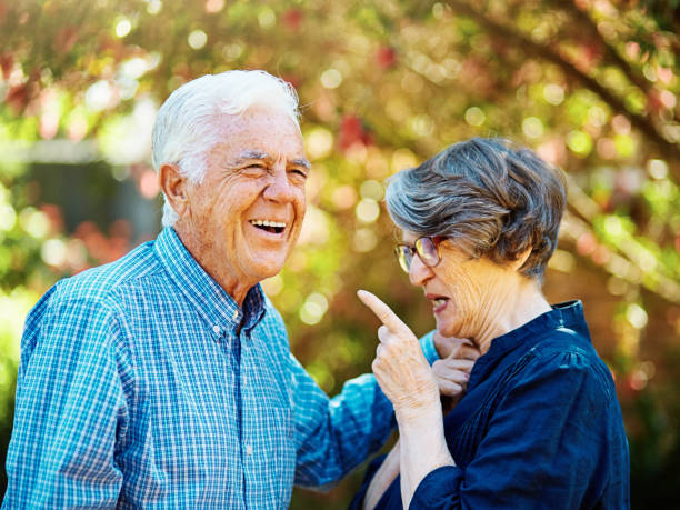 istock Elderly couple in their 70s have an amusing interaction outdoors in a sunny garden 1436097106