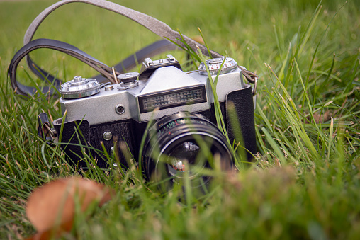 A vintage film camera on grass.