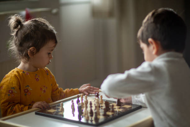 istock Little girl playing chess with her brother 1436098179