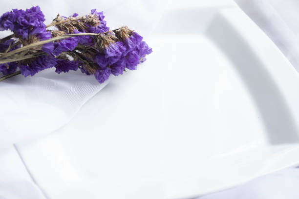 Purple flowers framed on a white background. Flat lay, top view.