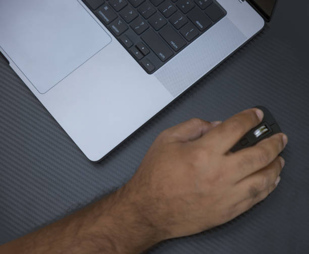 istock Close up view Indian man working on a laptop outdoors 1436099236