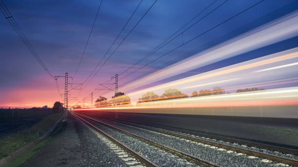 istock Light trail of high speed train on railroad track 1436101175