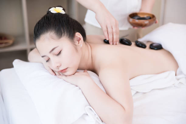 istock Spa massage with a hot stone massage at a beauty spa salon. 1436101991
