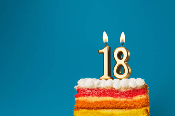 istock Rainbow cake dessert with 18 number candles birthday concept. 1436103163