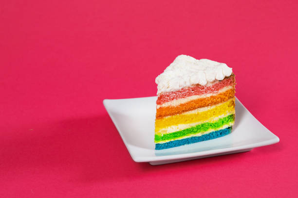 Sweet and tasty rainbow cake dessert on a red background.