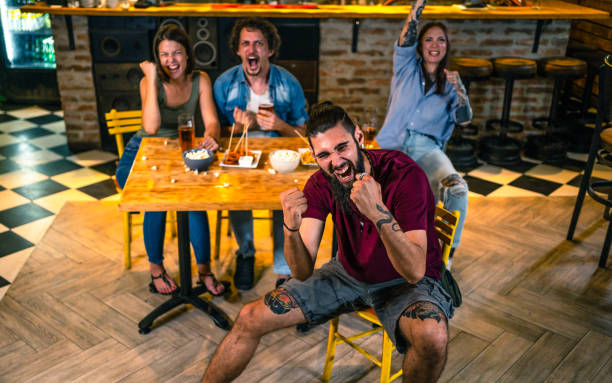 istock Young man watching a sports game in a bar 1436105936