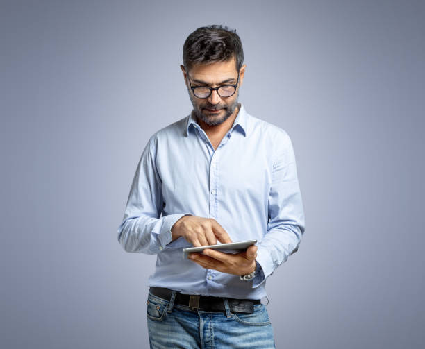 istock Portrait of focused man touching tablet 1436108446