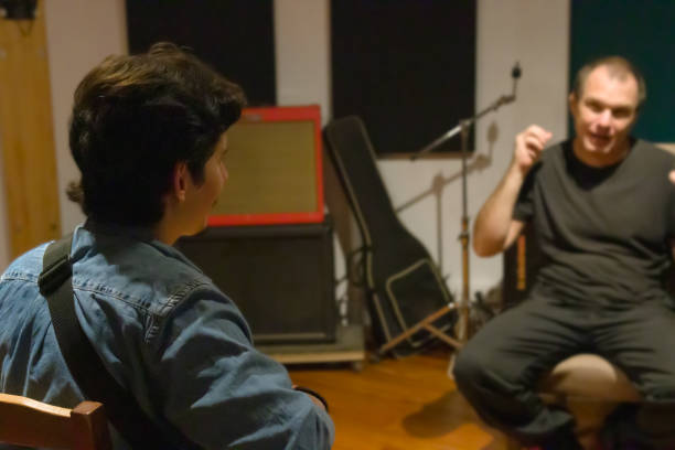 istock Shot focused on a student of music while receiving a class in a music studio 1436108534