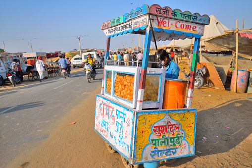 Pushkar, India - November 01, 2017: A man selling Panipuri, an Indian snack in a roadside stall.