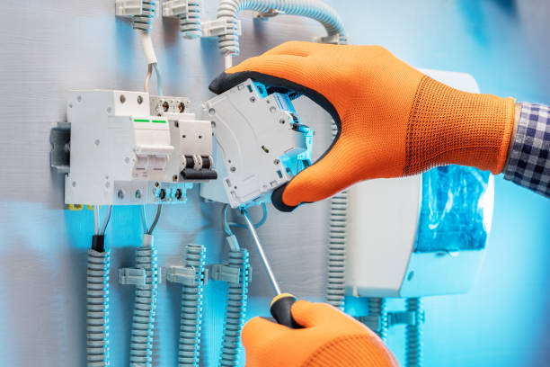 istock electrician installing electrical switch in an electrical cabinet control. repair concept. 1436110571