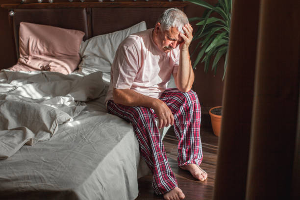istock Sad unhappy senior man seated on bed in bedroom 1436110727
