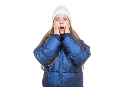 shocked teen girl in knitted hat and puffer padded jacket warm clothes isolated on white, down jacket.