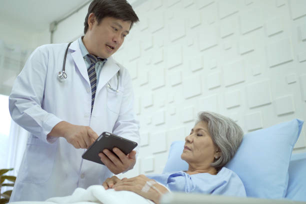 istock Doctor talking to elder female patient. 1436114608